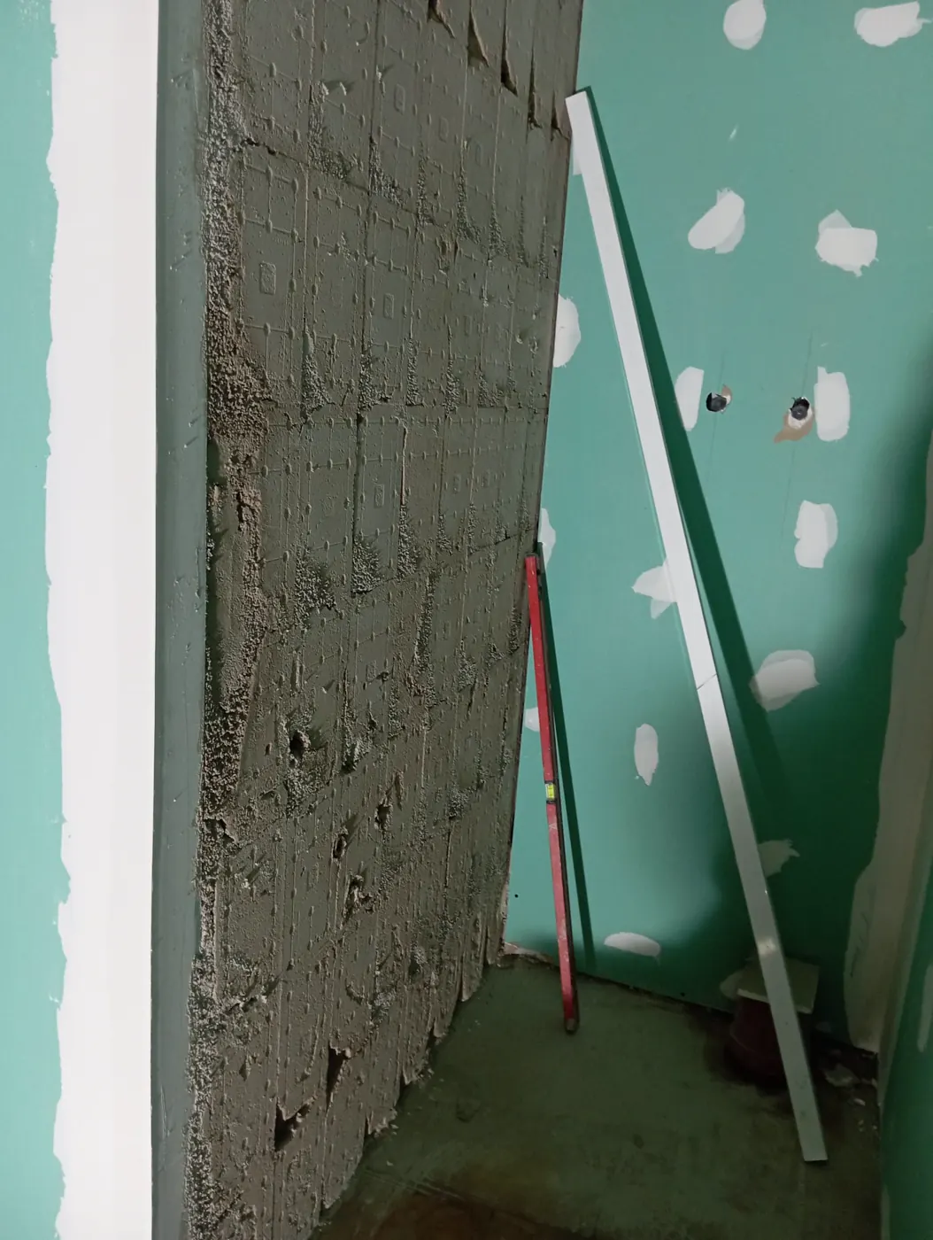 Pared preparada con enfoscado de mortero para alojar azulejos en reforma de local en Tarragona